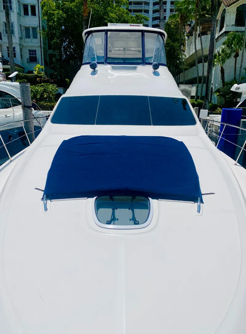 Slide: The Image of 2006 Sea Ray 580 Sedan Bridge yacht docked, featuring sleek design and spacious deck. - 18
