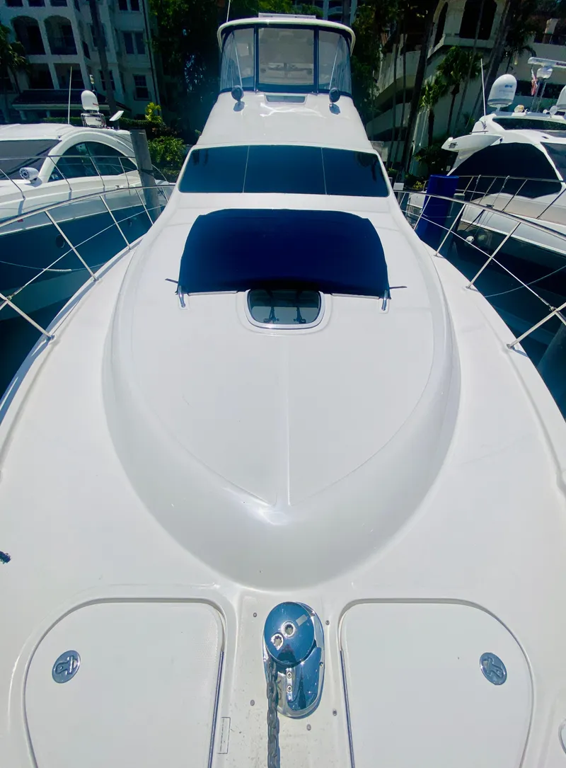 Slide: The Image of 2006 Sea Ray 580 Sedan Bridge yacht, sleek design, docked in marina. - 19