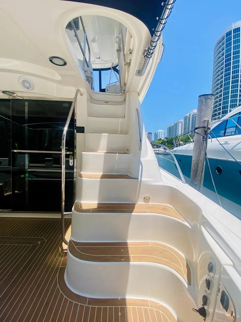 Slide: The Image of Staircase on 2006 Sea Ray 580 Sedan Bridge yacht with cityscape background. - 20
