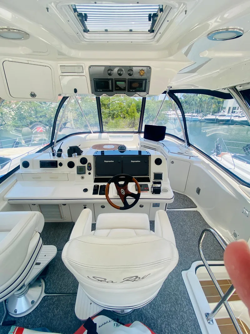 Slide: The Image of 2006 Sea Ray 580 Sedan Bridge helm with modern controls and panoramic windows. - 22