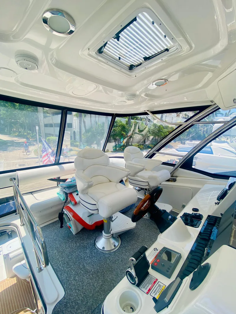 Slide: The Image of Interior of 2006 Sea Ray 580 Sedan Bridge yacht with plush seating and modern controls. - 26