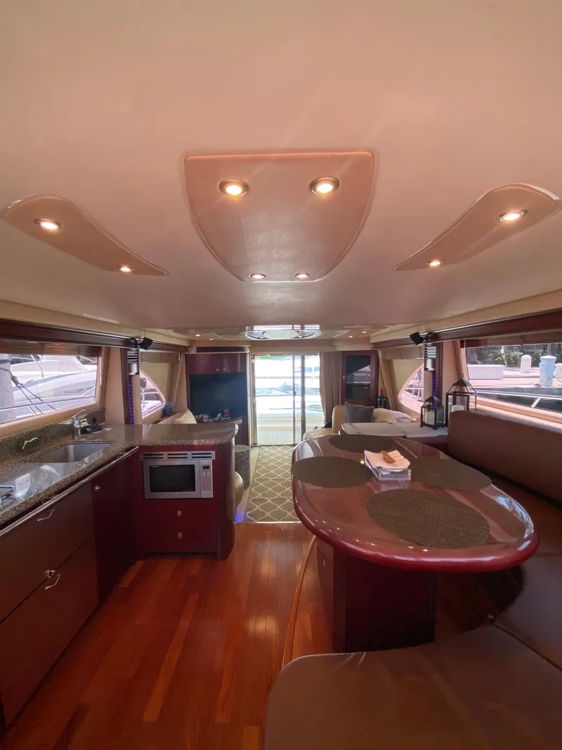 Slide: The Image of Interior of 2006 Sea Ray 580 Sedan Bridge yacht with modern kitchen and dining area. - 33