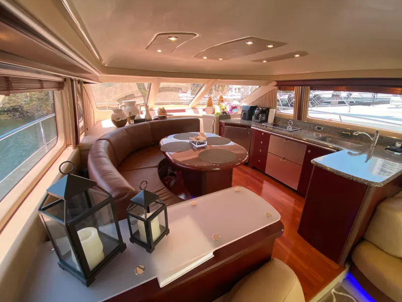 Slide: The Image of Luxurious interior of 2006 Sea Ray 580 Sedan Bridge yacht with elegant seating and kitchen area. - 34