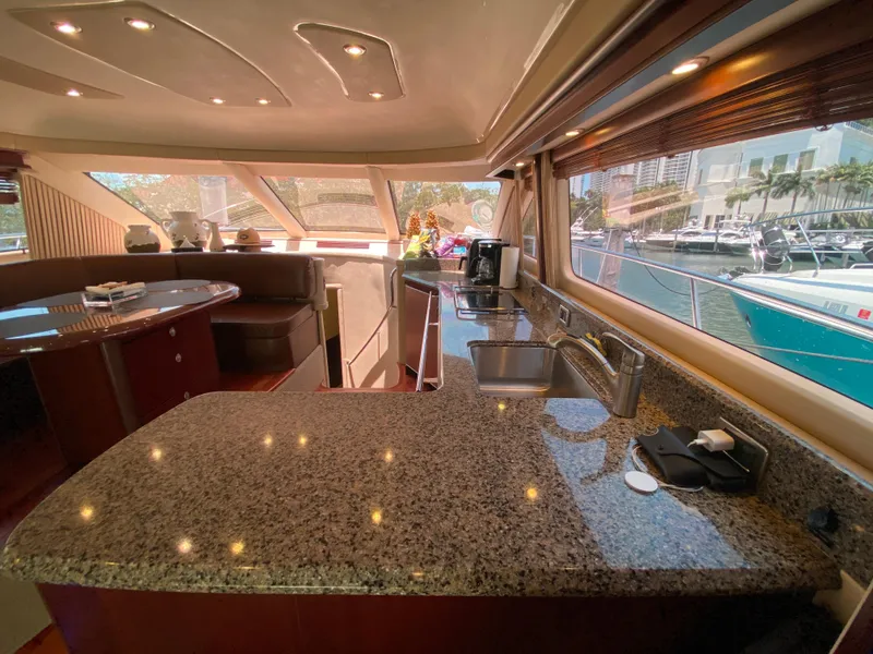 Slide: The Image of Luxurious 2006 Sea Ray 580 Sedan Bridge yacht interior with granite countertops and marina view. - 37