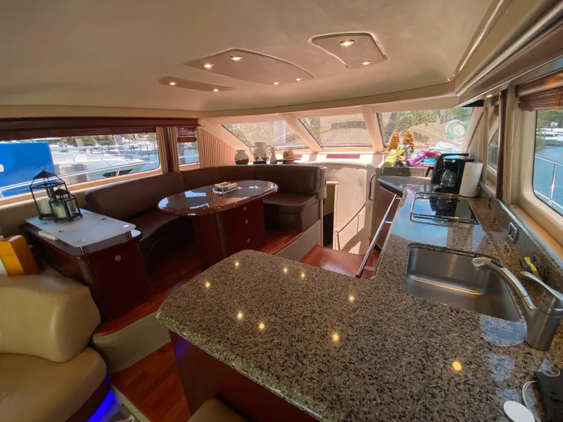 Slide: The Image of Luxurious interior of 2006 Sea Ray 580 Sedan Bridge yacht with granite countertops and plush seating. - 38