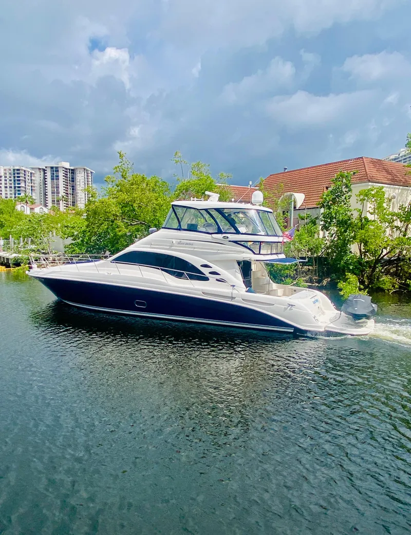 Slide: The Image of 2006 Sea Ray 580 Sedan Bridge yacht cruising on a scenic waterway. - 4