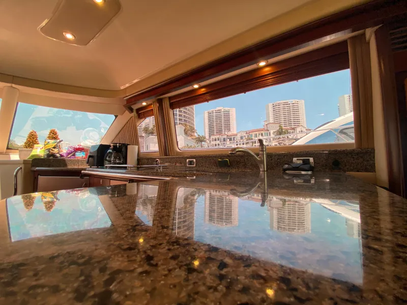 Slide: The Image of Luxurious interior of 2006 Sea Ray 580 Sedan Bridge yacht with cityscape view. - 40