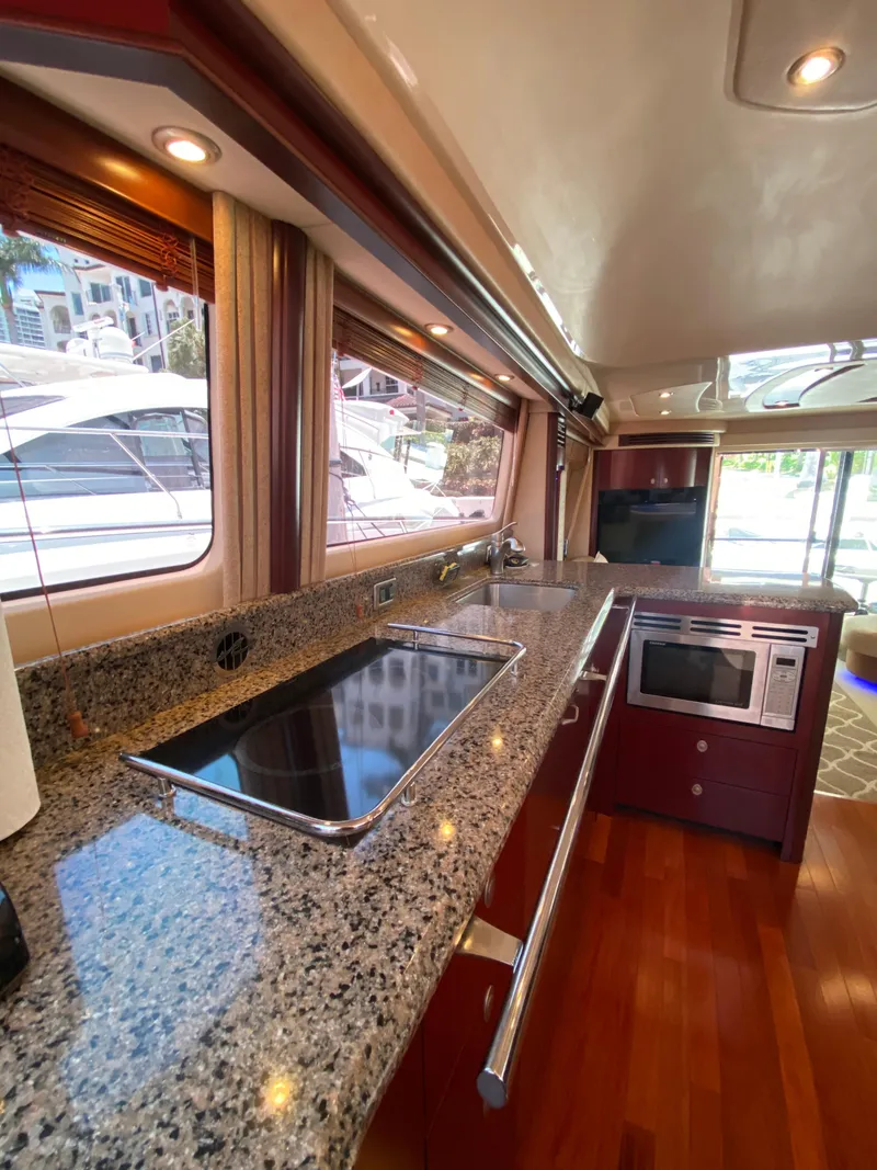 Slide: The Image of Luxurious kitchen interior of 2006 Sea Ray 580 Sedan Bridge yacht with granite countertops. - 41