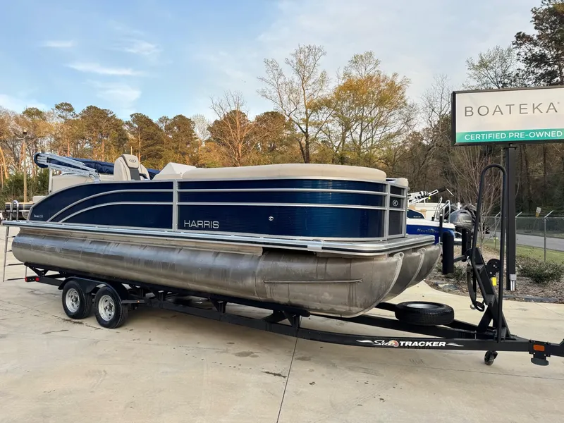 Slide: The Image of 2023 Harris 230 CRUISER pontoon boat on trailer at Boateka dealership. - 1