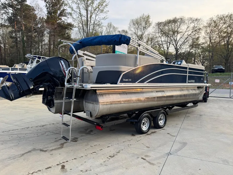 Slide: The Image of 2023 Harris 230 CRUISER pontoon boat on trailer, parked outdoors. - 3