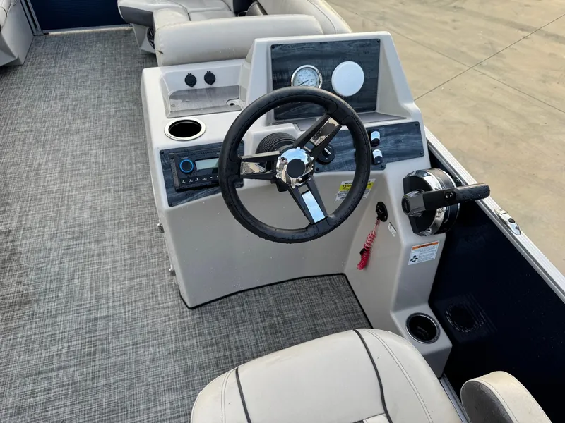 Slide: The Image of 2023 Harris 230 CRUISER boat interior with steering wheel and control panel. - 6