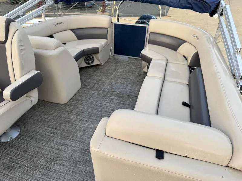 Slide: The Image of 2023 Harris 230 CRUISER boat interior with beige seating and gray accents. - 8