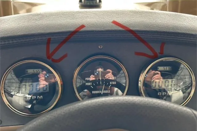 Slide: The Image of Dashboard of 2003 Carver 410 Sport Sedan with RPM and rudder angle gauges. - 105