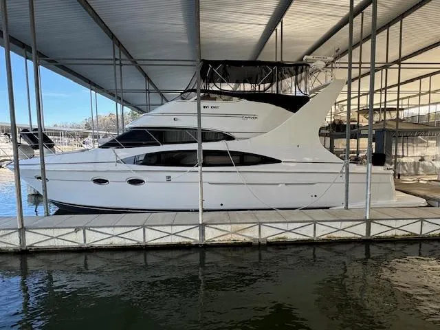 Slide: The Image of 2003 Carver 410 Sport Sedan docked in a covered marina. - 11