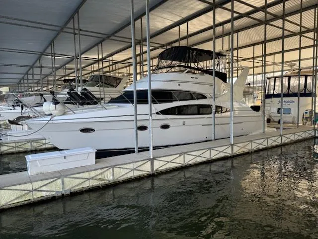 Slide: The Image of 2003 Carver 410 Sport Sedan yacht docked in a covered marina. - 12