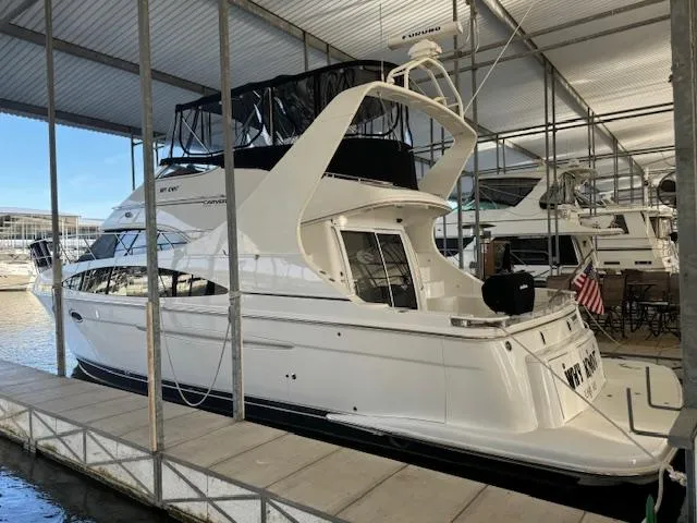 Slide: The Image of 2003 Carver 410 Sport Sedan docked in a covered marina. - 13