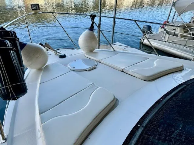 Slide: The Image of 2003 Carver 410 Sport Sedan yacht with sunbathing deck, docked on calm water. - 14