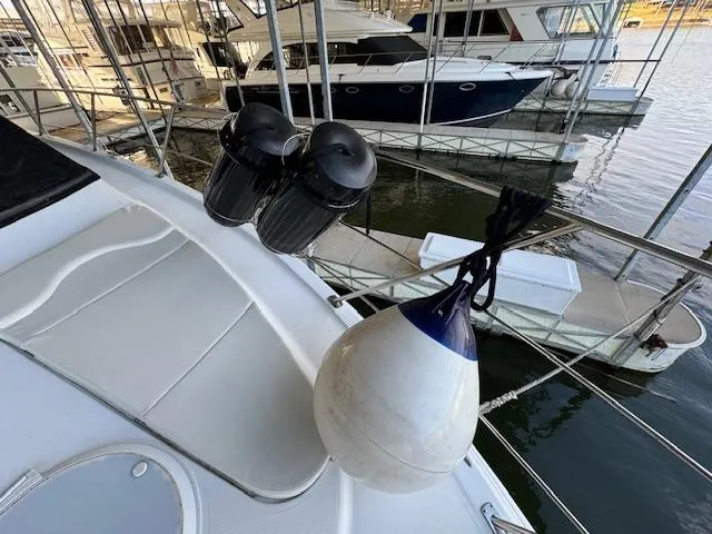 Slide: The Image of 2003 Carver 410 Sport Sedan docked, featuring deck details and marina view. - 17