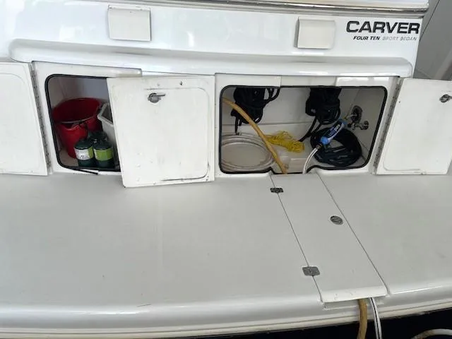 Slide: The Image of 2003 Carver 410 Sport Sedan boat storage compartments with equipment and supplies. - 19