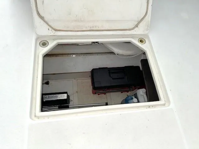 Slide: The Image of Storage compartment on a 2003 Carver 410 Sport Sedan boat, featuring tools and equipment. - 23