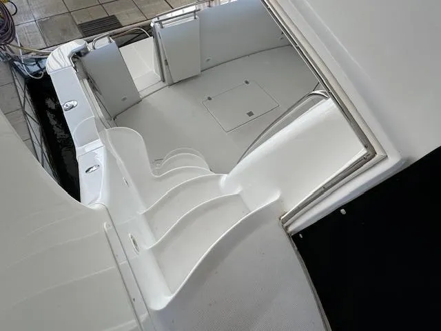 Slide: The Image of 2003 Carver 410 Sport Sedan boat interior with white seating and deck. - 25