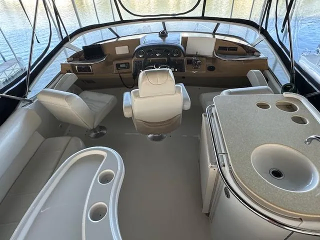 Slide: The Image of 2003 Carver 410 Sport Sedan cockpit with helm, seating, and kitchenette. - 26