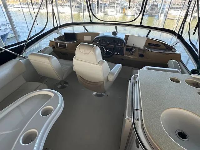 Slide: The Image of Interior of 2003 Carver 410 Sport Sedan yacht with helm, seating, and kitchenette. - 27