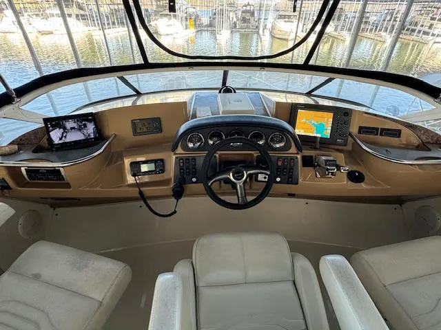 Slide: The Image of Interior cockpit of 2003 Carver 410 Sport Sedan with navigation equipment and steering wheel. - 28