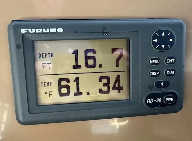 Slide: The Image of Furuno depth and temperature display on 2003 Carver 410 Sport Sedan, showing 16.7 ft depth, 61.34°F. - 33