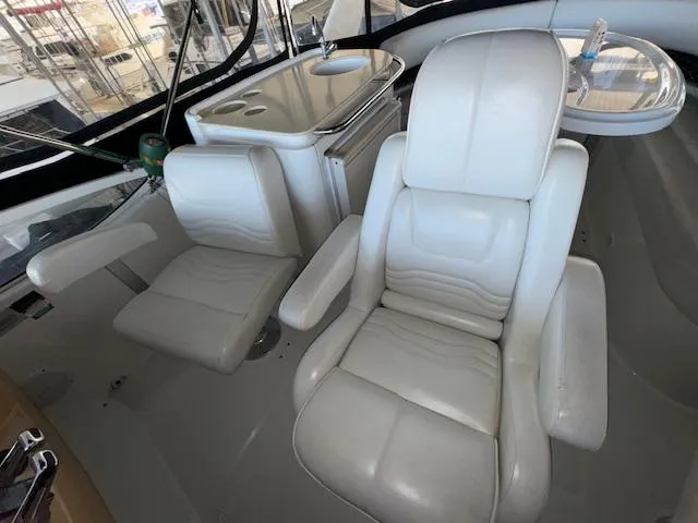 Slide: The Image of 2003 Carver 410 Sport Sedan interior with white leather seats and compact kitchenette. - 35