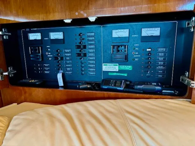 Slide: The Image of Electrical control panel inside 2003 Carver 410 Sport Sedan yacht, featuring various switches and meters. - 45