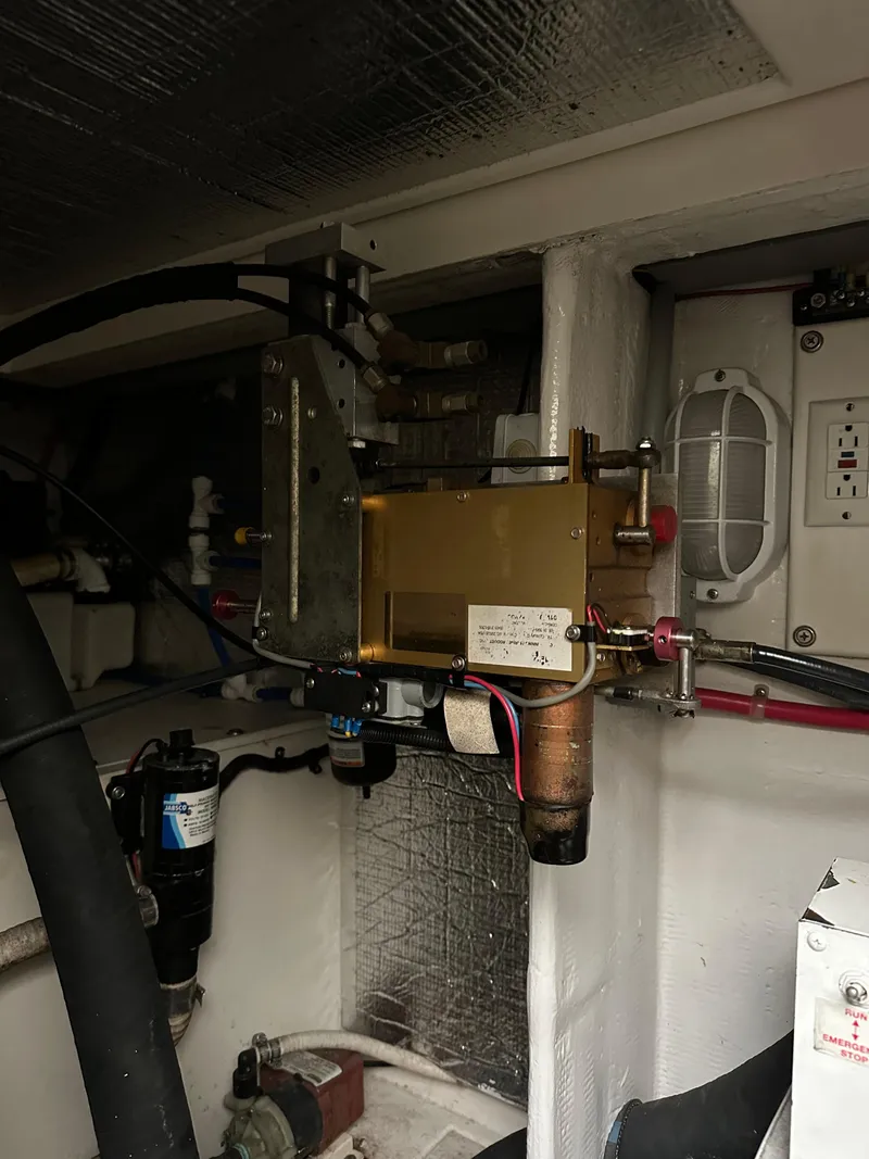 Slide: The Image of Engine room of a 2000 Cabo 35 Express boat, showcasing mechanical components and wiring. - 10