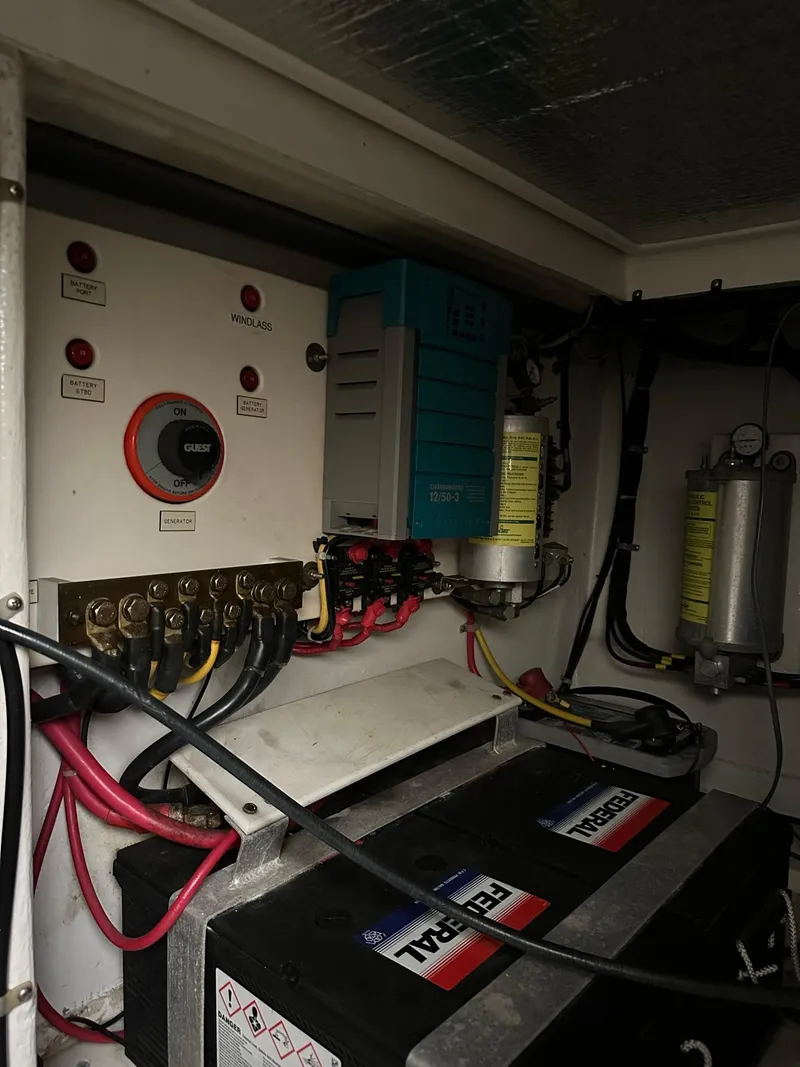 Slide: The Image of Electrical panel and battery setup in a 2000 Cabo 35 Express boat. - 12