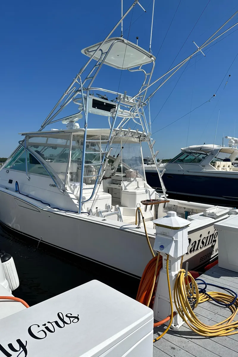 Slide: The Image of 2000 Cabo 35 Express boat docked under clear blue sky. - 14