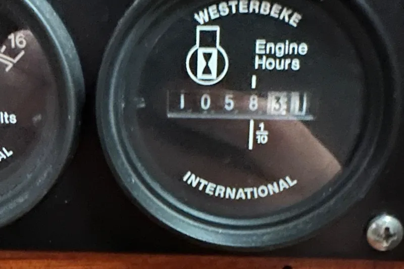 Slide: The Image of Westerbeke engine hour meter showing 1058.3 hours on a 2000 Cabo 35 Express. - 15