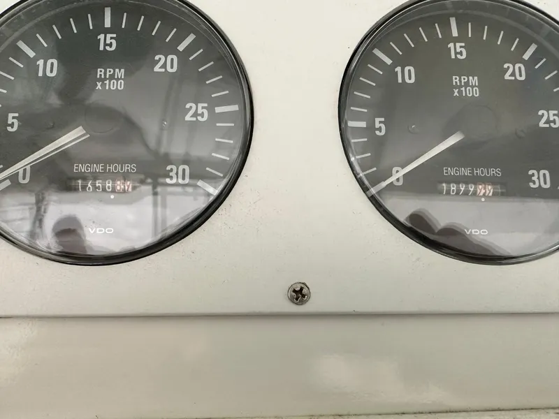 Slide: The Image of Close-up of Cabo 35 Express 2000 engine RPM gauges displaying engine hours. - 5