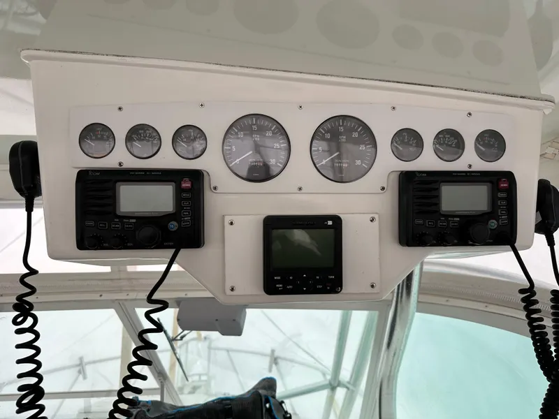 Slide: The Image of Control panel of a 2000 Cabo 35 Express boat with gauges and communication devices. - 7