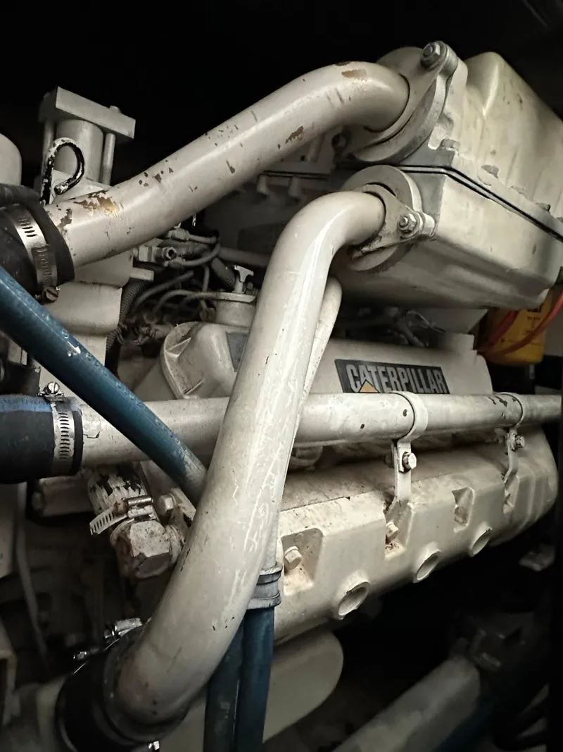 Slide: The Image of Cabo 35 Express 2000 engine compartment featuring Caterpillar components and piping. - 8