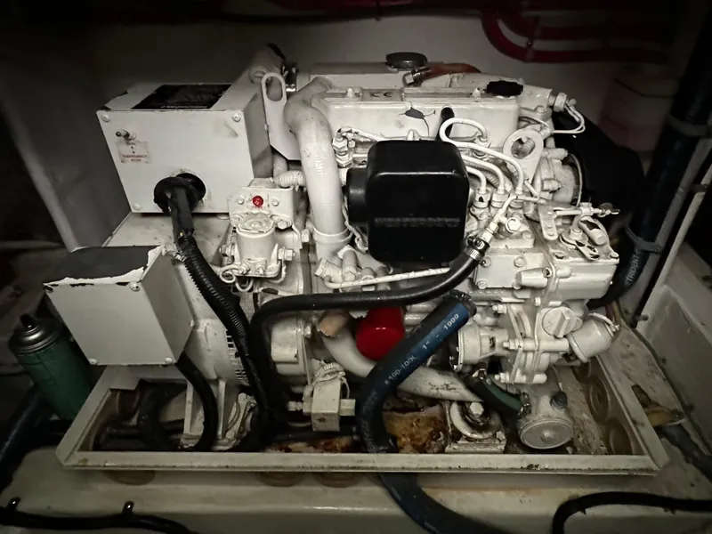 Slide: The Image of Engine of a 2000 Cabo 35 Express boat, showcasing intricate mechanical components. - 9