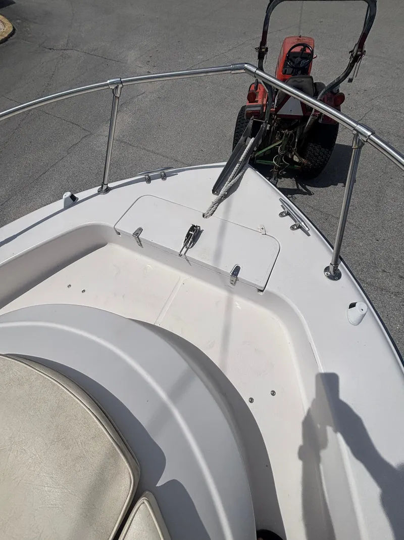 Slide: The Image of 2000 Grady-White 228 Seafarer boat bow with railing and anchor, parked on pavement. - 12