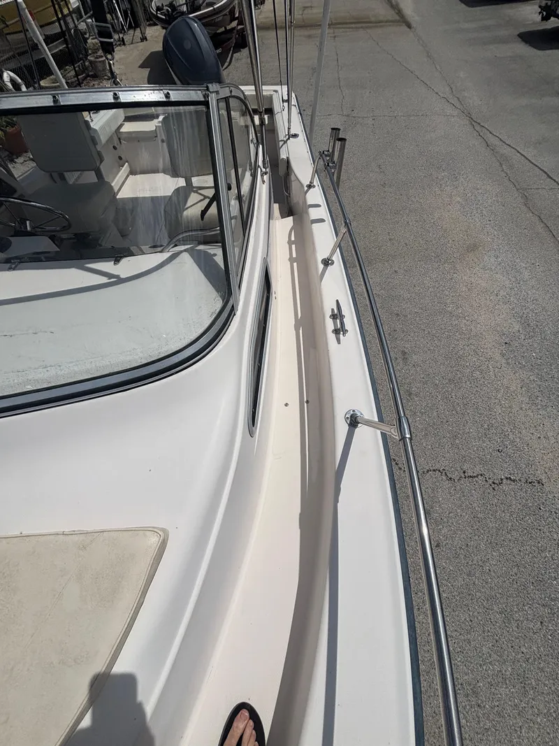 Slide: The Image of 2000 Grady-White 228 Seafarer boat deck view with railing and windshield. - 13