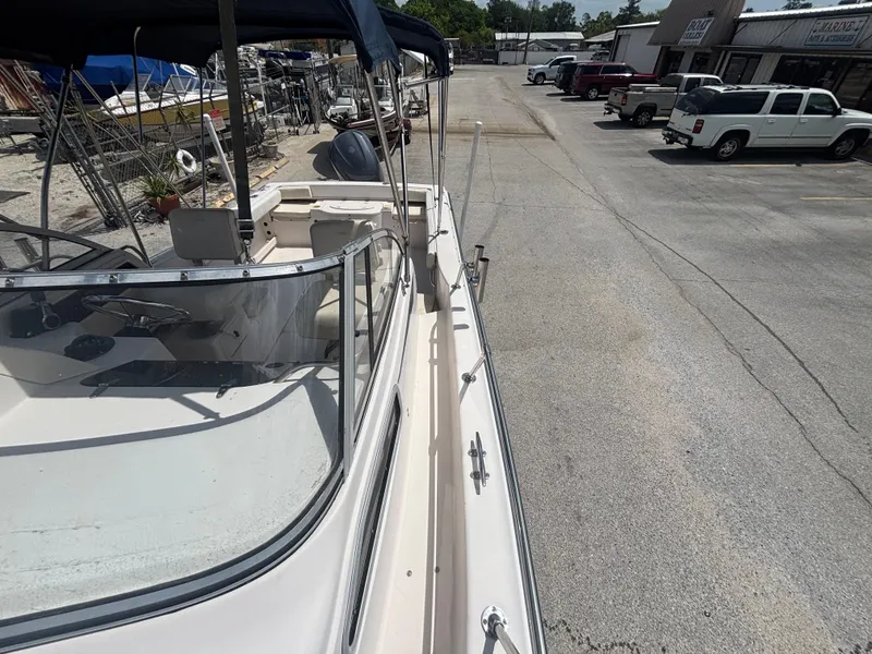 Slide: The Image of 2000 Grady-White 228 Seafarer boat parked in a marina lot, side view. - 17