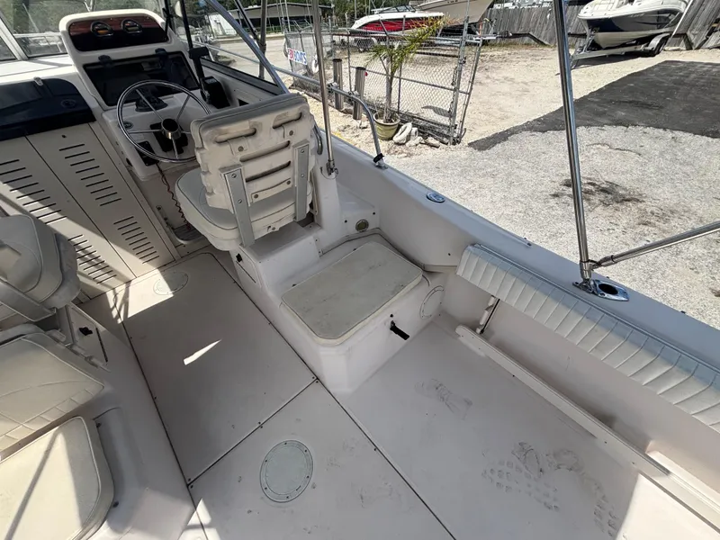 Slide: The Image of 2000 Grady-White 228 Seafarer boat interior with helm, seating, and storage compartments. - 24