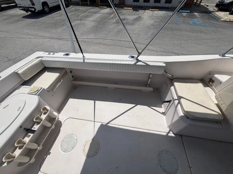 Slide: The Image of 2000 Grady-White 228 Seafarer boat interior with seating and rod holders. - 28