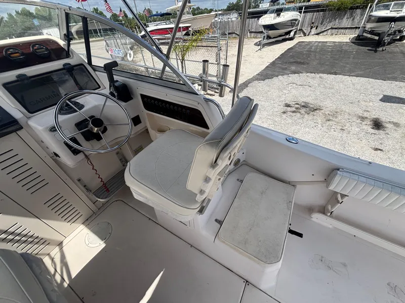 Slide: The Image of 2000 Grady-White 228 Seafarer boat interior with steering wheel and seating area. - 31