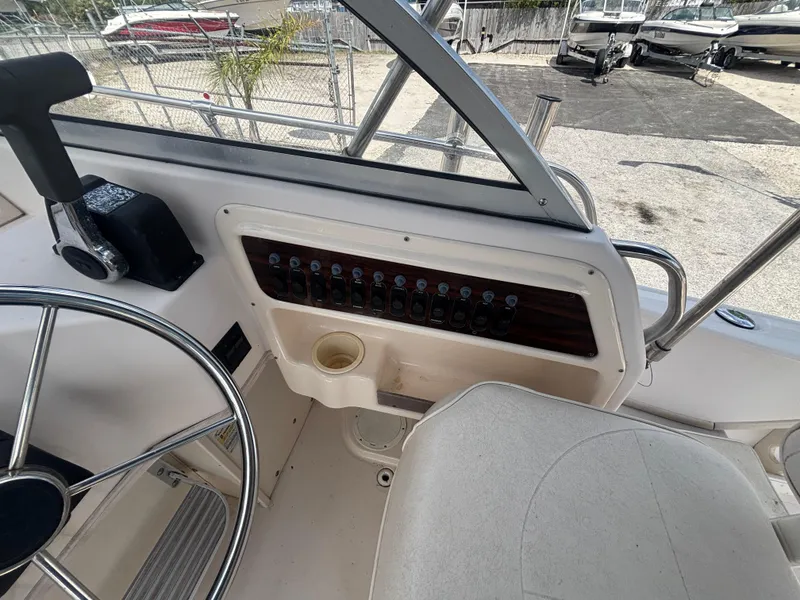 Slide: The Image of Helm of 2000 Grady-White 228 Seafarer boat with steering wheel and control panel. - 33