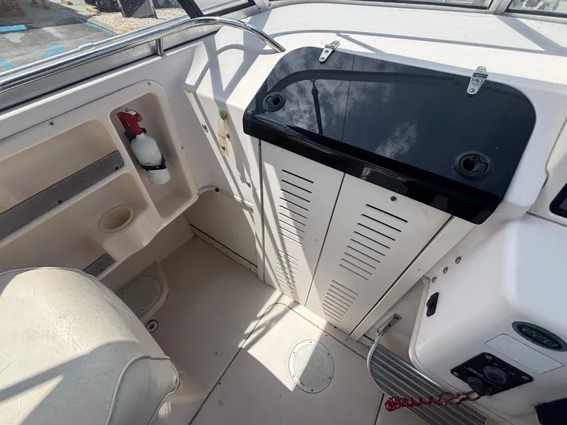 Slide: The Image of 2000 Grady-White 228 Seafarer boat interior with storage and fire extinguisher. - 36