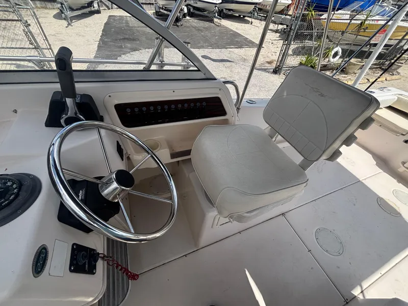 Slide: The Image of 2000 Grady-White 228 Seafarer boat helm with steering wheel and captain's chair. - 38