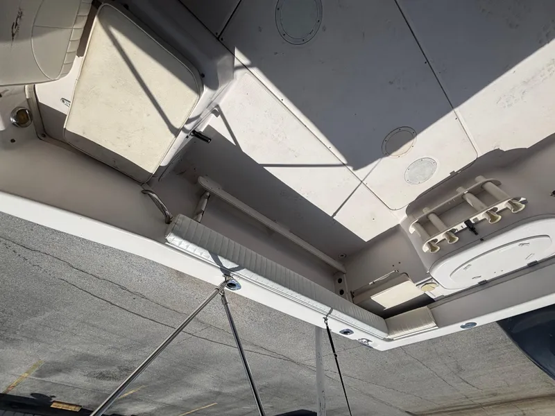 Slide: The Image of 2000 Grady-White 228 Seafarer boat deck with storage compartments and rod holders. - 43