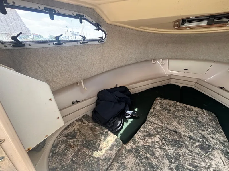 Slide: The Image of Interior cabin of 2000 Grady-White 228 Seafarer boat, featuring seating and storage. - 47